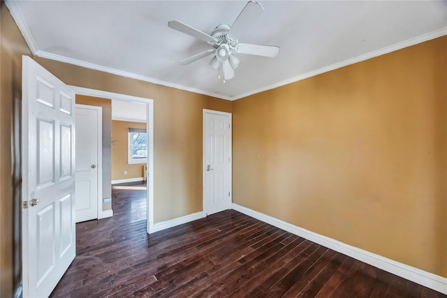 empty room with dark hardwood / wood-style flooring, ornamental molding, and ceiling fan