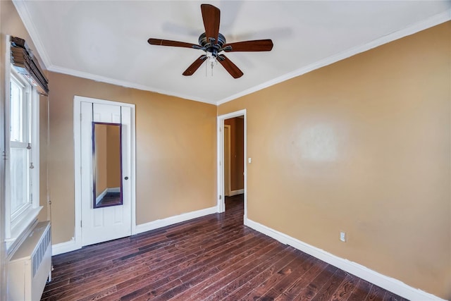 spare room with ceiling fan, ornamental molding, dark hardwood / wood-style flooring, and radiator heating unit