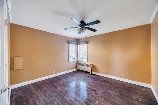 empty room with dark wood-type flooring, ceiling fan, crown molding, and radiator