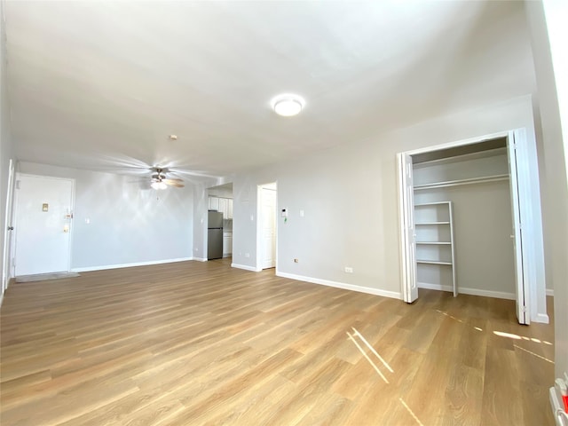 unfurnished living room with ceiling fan and light hardwood / wood-style flooring