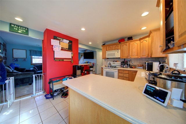 kitchen featuring tasteful backsplash, light tile patterned floors, white appliances, and kitchen peninsula