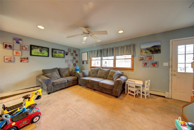 living room with ceiling fan, light colored carpet, and baseboard heating