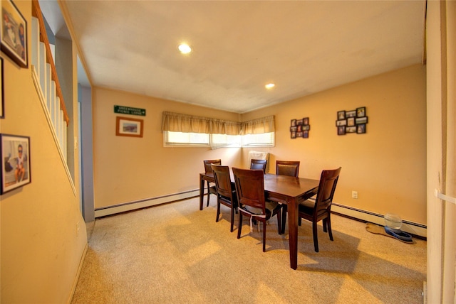 dining area featuring light carpet and a baseboard heating unit