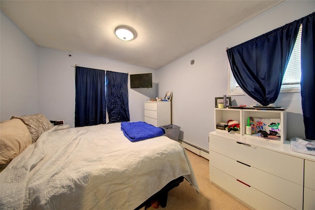 bedroom with baseboard heating, vaulted ceiling, and light carpet