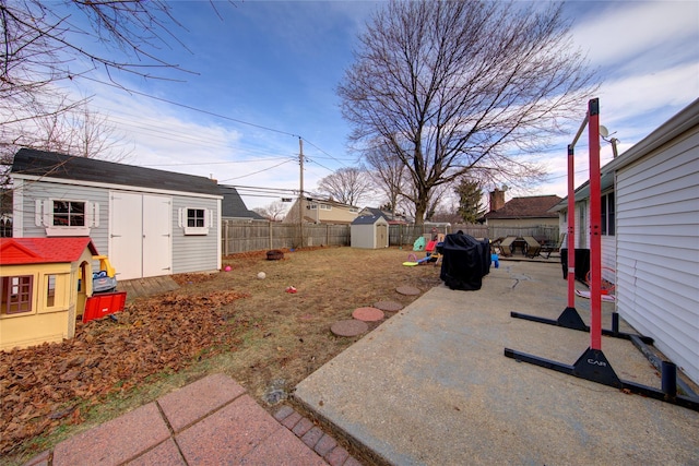 view of yard with a storage unit and a patio area