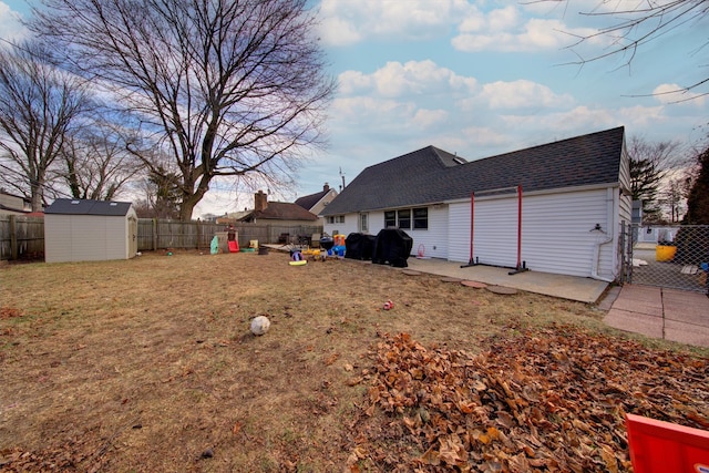 view of yard with a playground, a patio area, and a shed