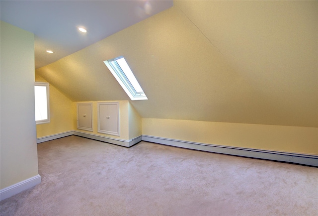 bonus room with carpet, recessed lighting, a baseboard radiator, vaulted ceiling with skylight, and baseboards