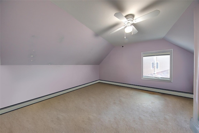 additional living space featuring vaulted ceiling and carpet flooring