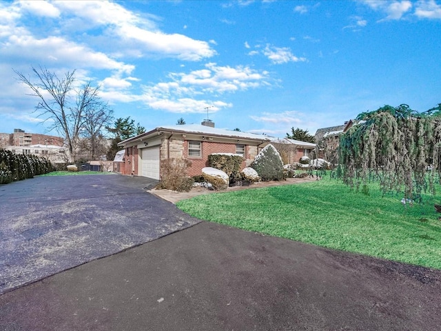 view of side of home with a garage and a lawn