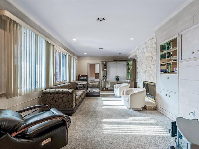 living room featuring crown molding, a fireplace, and carpet floors