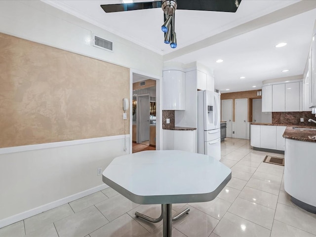 dining space featuring sink and light tile patterned floors