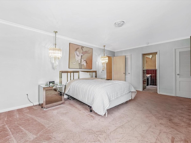 bedroom featuring an inviting chandelier, ornamental molding, ensuite bathroom, and carpet