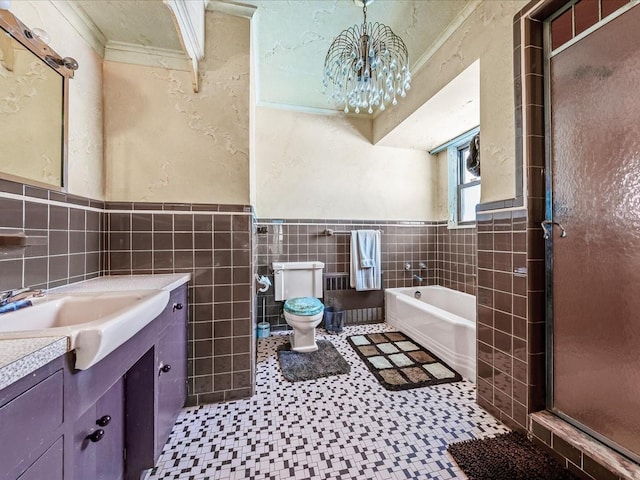 full bathroom featuring crown molding, tile walls, separate shower and tub, vanity, and toilet