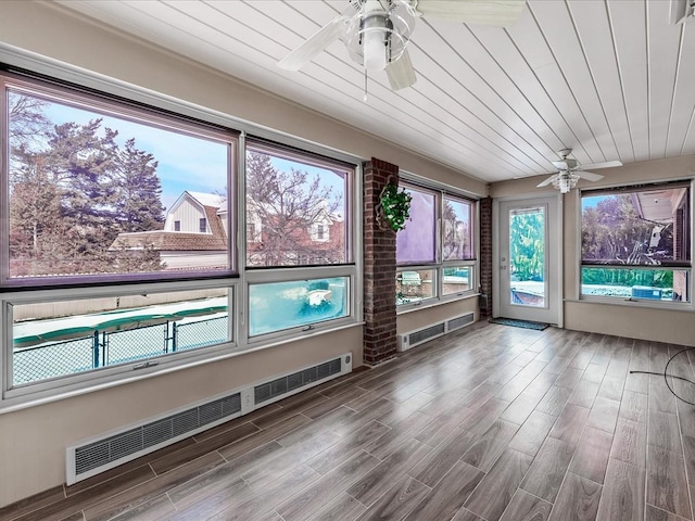 unfurnished sunroom with wooden ceiling and ceiling fan