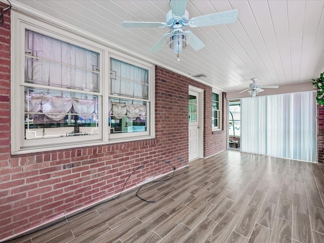 exterior space featuring ceiling fan and wooden ceiling