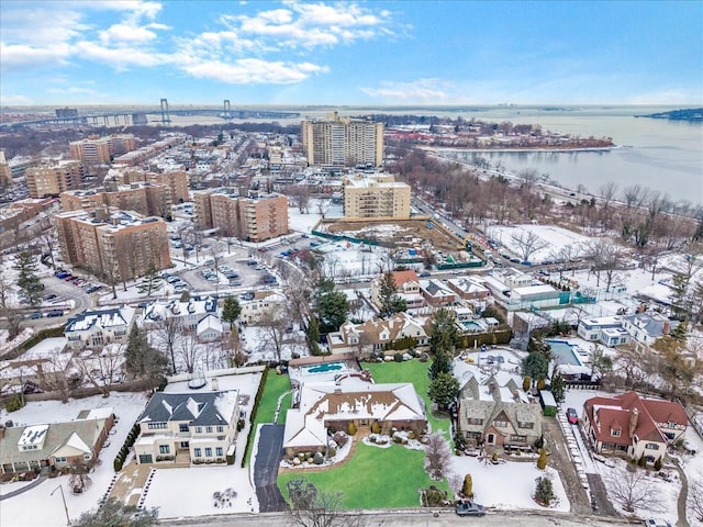 snowy aerial view featuring a water view