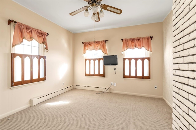 unfurnished room with a baseboard heating unit, plenty of natural light, ceiling fan, and carpet