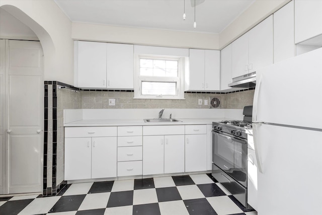 kitchen with white fridge, sink, white cabinets, and black range with gas cooktop