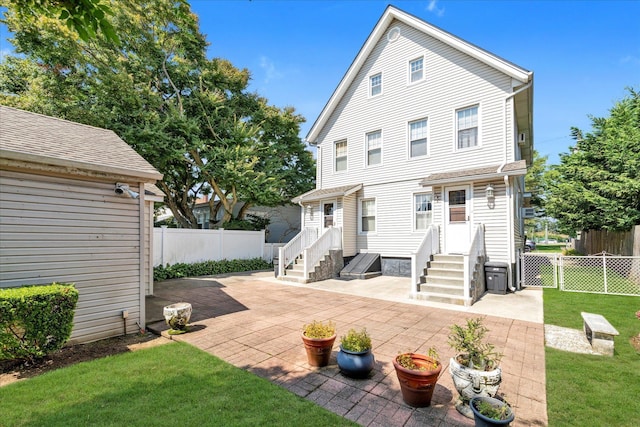 rear view of property with a patio area and a lawn