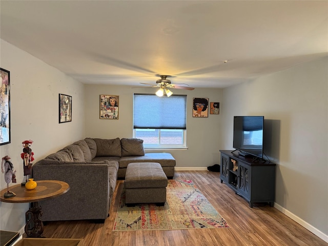 living room featuring wood-type flooring and ceiling fan