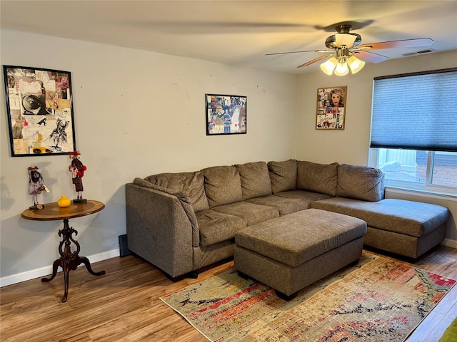 living room featuring hardwood / wood-style flooring and ceiling fan