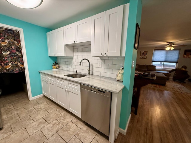 kitchen with sink, dishwasher, white cabinets, ceiling fan, and backsplash