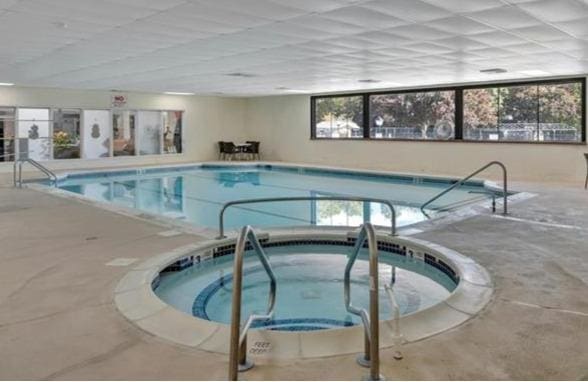 view of swimming pool with an indoor in ground hot tub