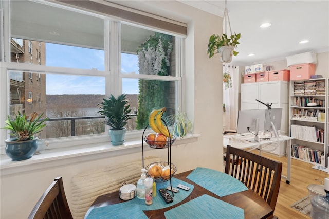 dining room featuring ornamental molding and light hardwood / wood-style floors