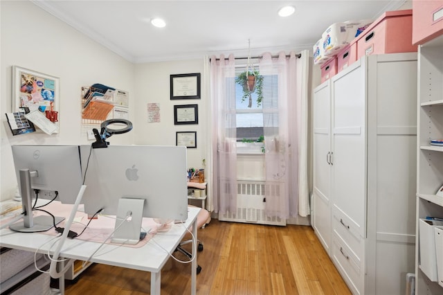 home office with ornamental molding, radiator, and light wood-type flooring