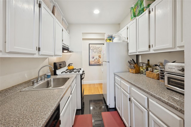 kitchen with white appliances, sink, and white cabinets