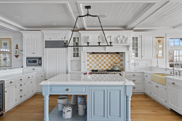 kitchen featuring tasteful backsplash, sink, a center island, and pendant lighting