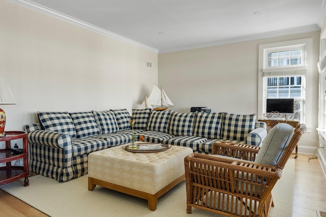 living room with crown molding and light wood-type flooring