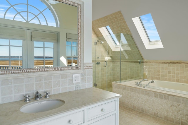 bathroom featuring plenty of natural light, lofted ceiling with skylight, shower with separate bathtub, and a water view