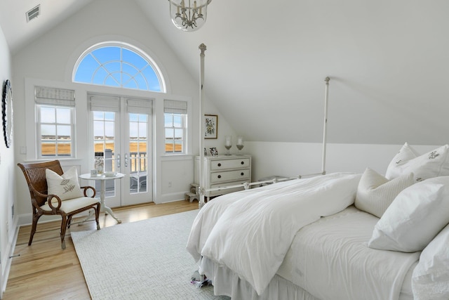 bedroom featuring lofted ceiling, access to outside, french doors, and light wood-type flooring