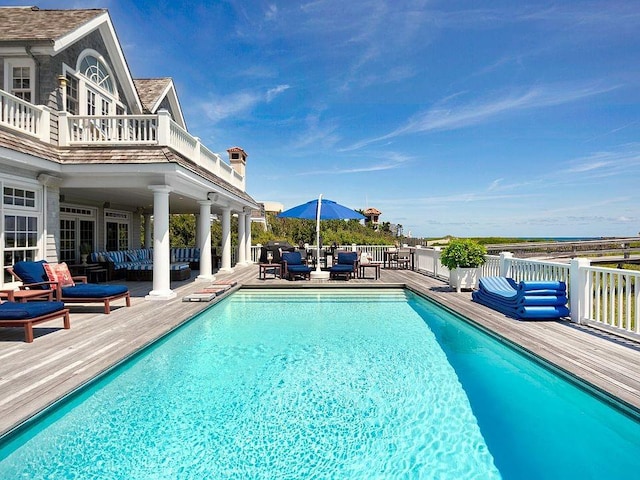 view of swimming pool with a wooden deck and outdoor lounge area