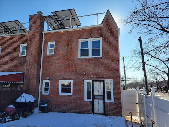 view of snow covered rear of property