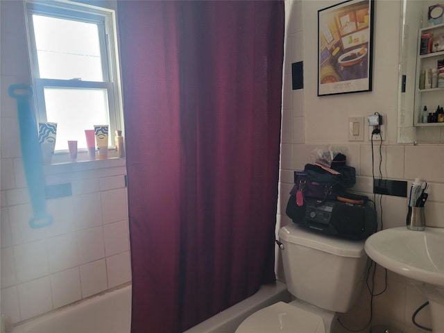 bathroom featuring toilet, shower / bathtub combination with curtain, and tile walls