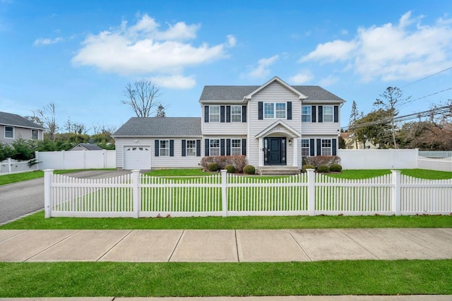 colonial-style house with a garage and a front yard