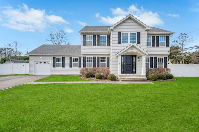 colonial-style house with a garage and a front lawn