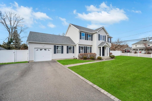 view of front of house with a garage and a front yard