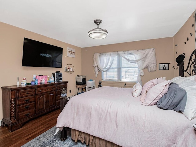 bedroom with dark wood-type flooring