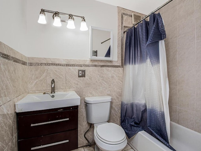 full bathroom featuring tile walls, shower / tub combo, vanity, tile patterned floors, and toilet