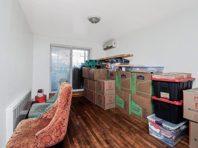 living area featuring radiator heating unit, dark hardwood / wood-style floors, and a wall mounted AC