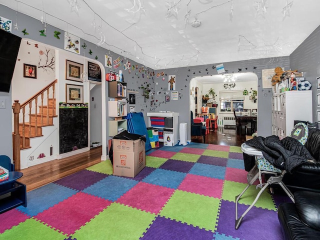 recreation room with dark wood-type flooring