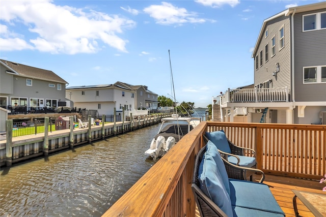 view of dock with a water view and a residential view