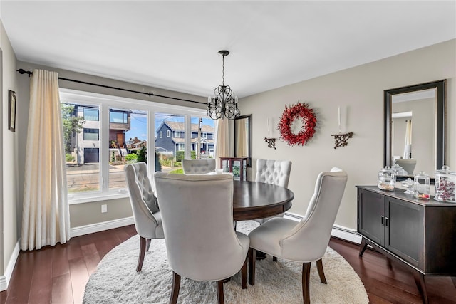 dining area featuring a baseboard radiator, plenty of natural light, dark hardwood / wood-style flooring, and a notable chandelier