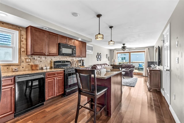 kitchen with a breakfast bar, hanging light fixtures, wine cooler, tasteful backsplash, and black appliances