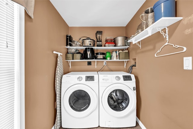 clothes washing area with washer and clothes dryer