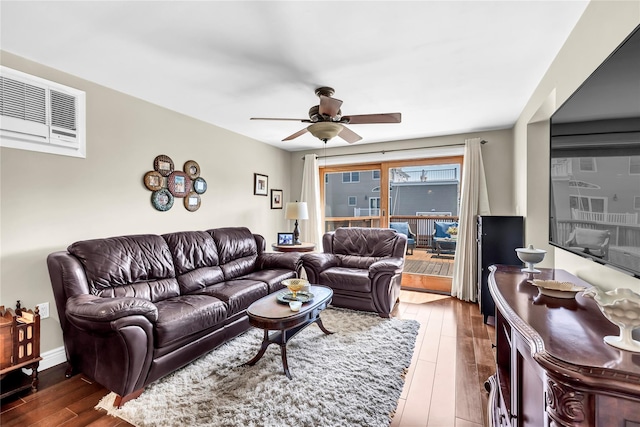 living room featuring wood-type flooring and ceiling fan