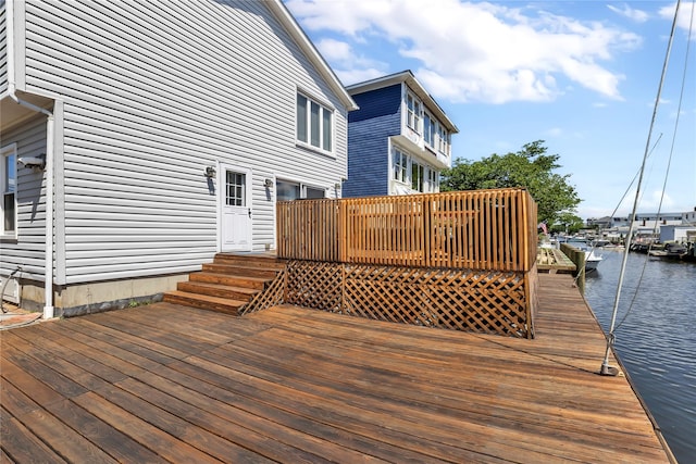 wooden terrace featuring a water view